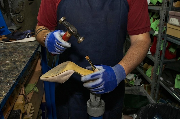 young-shoemaker-mending-footwear-repair-shop_545448-1874.jpg